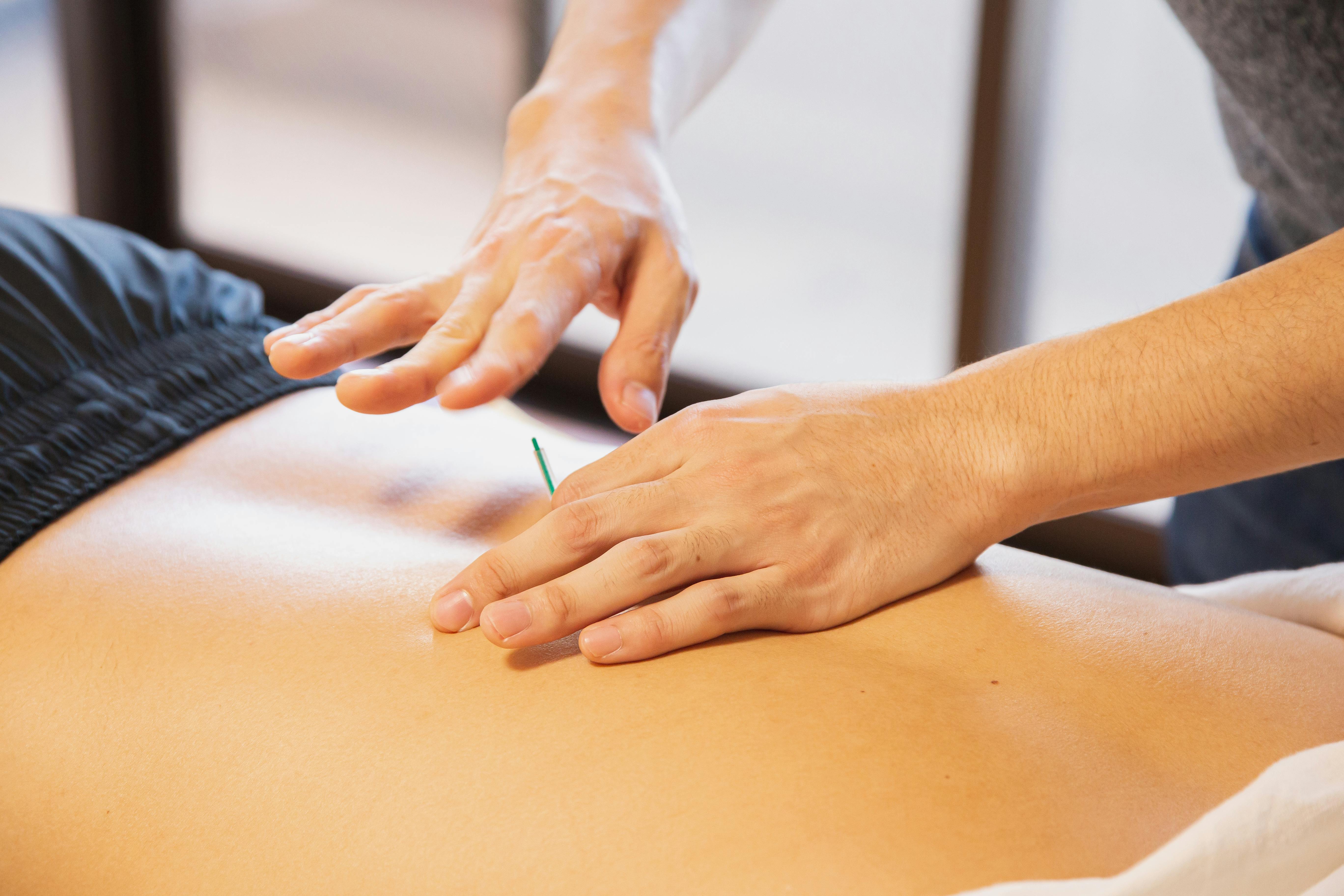 Person using a heating pad for back pain relief — AllCare Store heat therapy guide